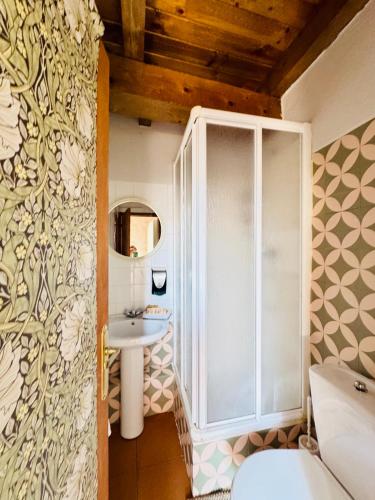 a bathroom with a shower and a sink at Casa Uishera in Vilamós