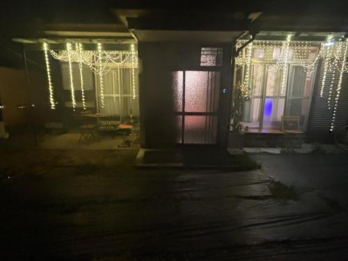 a house lit up at night with christmas lights at One room Pusang Gala Yuki City in Yuki