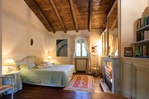a bedroom with a bed and a table and a window at Antica Cascina del Medico in Muzzano
