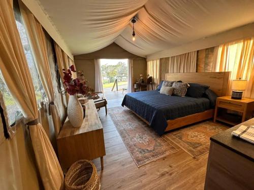 a bedroom with a bed in a tent at Premium Lakefront Cabin 4 The Cardinal in Bastrop