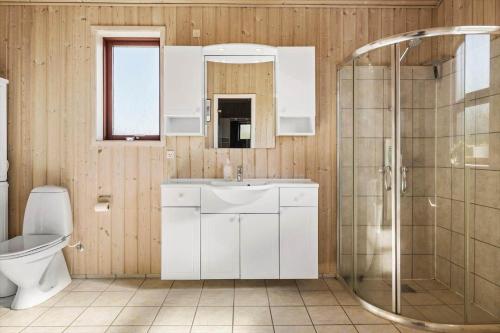 a bathroom with a toilet and a sink and a shower at OH490-Hadsund-Halvrebene-76 in Hadsund
