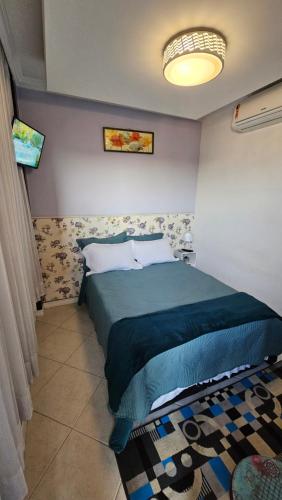 Ένα ή περισσότερα κρεβάτια σε δωμάτιο στο Suite Grande Rio - Ar condicionado