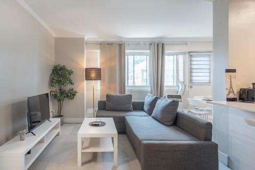 a living room with a couch and a table at Cozy 1BR - Heart of Montreal in Montréal
