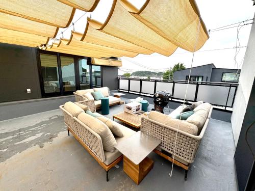 a patio with couches and a table on a balcony at Tsubame Zushi Hayama in Zushi