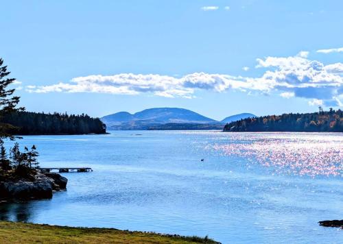 a view of a lake with mountains in the background at Lobster Pound Beach House in Hancock