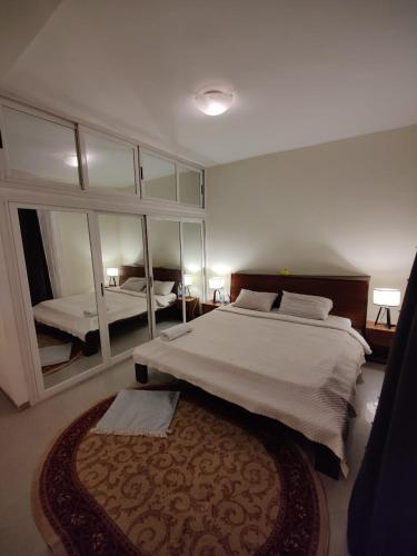 a bedroom with a large bed and a large mirror at Center appart chez ZENA in Dakar