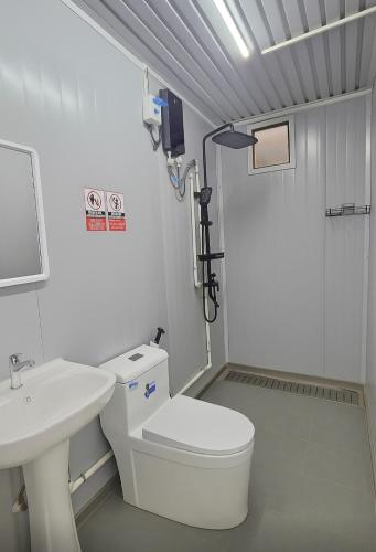 a bathroom with a white toilet and a sink at Banana Bar San Juan Family Digital Nomad Stay Starlink Fast WiFi Solar Backup in San Juan