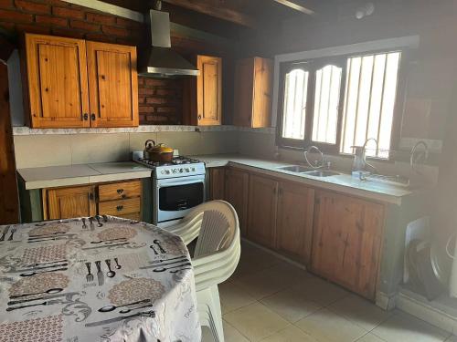 a kitchen with a table and a stove top oven at Casa de descanso Emiliano in Salta
