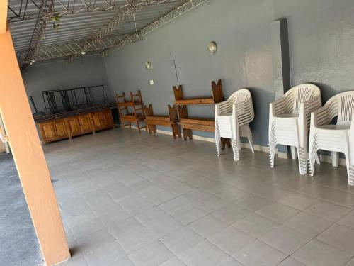a group of white chairs and a table in a room at Casa de descanso Emiliano in Salta