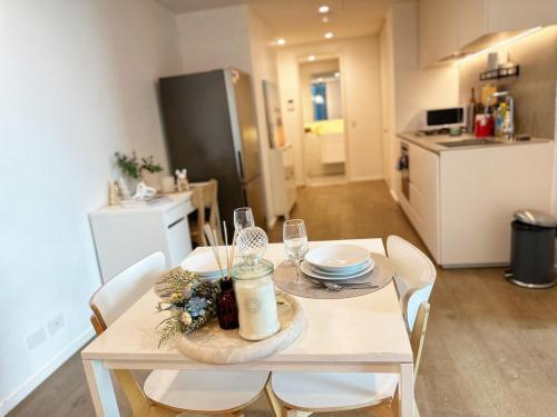 a dining room table with chairs and a kitchen at 3415 - 2BR Luxury Suite #Free Car Parking# Retreat Near Crown in Melbourne
