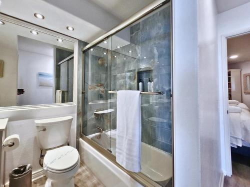 a bathroom with a toilet and a glass shower at Modern Coastal Escape Breathtaking Ocean in Imperial Beach