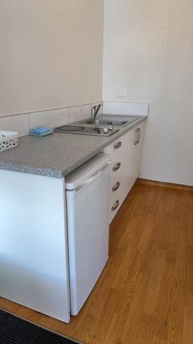 a kitchen with a sink and a counter top at Achilles Motel in Christchurch