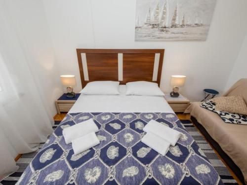 a bedroom with a large bed with two pillows at Apartments Scerbe Gordana & Miljenko Rab - Studio Apartment with Terrace 4 in Otok Rab