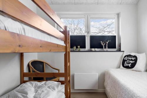 a small bedroom with a bunk bed and a window at LF10362-Hurup-Thy-Fjordstraede-25 in Doverodde