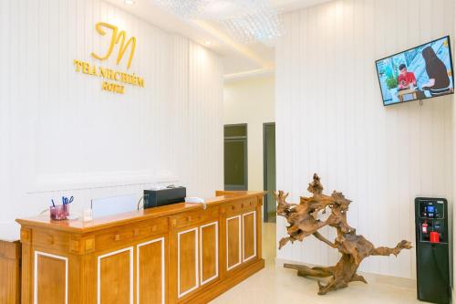 a room with a wooden counter and a sign on the wall at Thành Nghiêm Hotel Ninh Hòa in Ninh Hòa