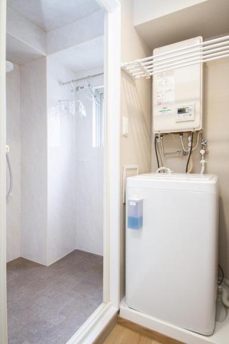a bathroom with a white refrigerator and a shower at M House 301 Tokyo Omori駅 in Tokyo