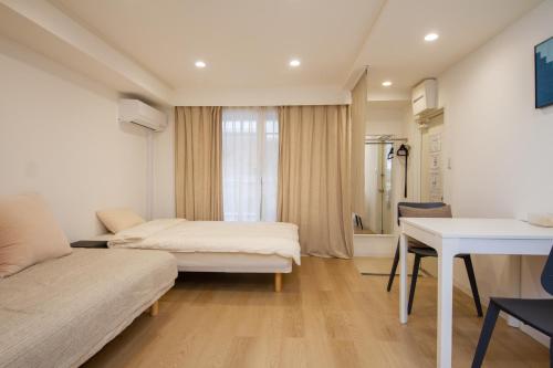 a hotel room with two beds and a desk at M House 301 Tokyo Omori駅 in Tokyo