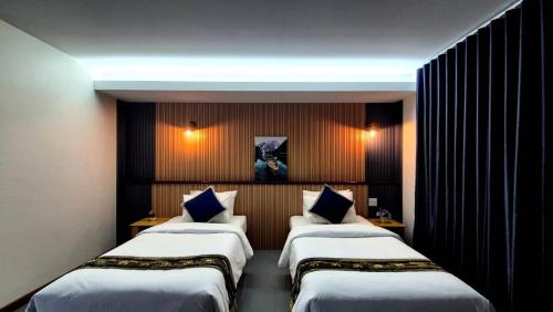 a hotel room with three beds in a room at The River khaosok in Khao Sok