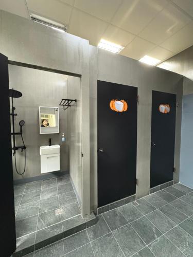 a bathroom with two black doors and a sink at Puli Town B&B in Puli