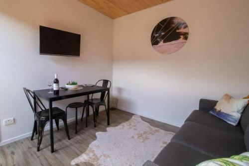 a living room with a table and a couch at The Dunes at Fitzroy Beach in New Plymouth