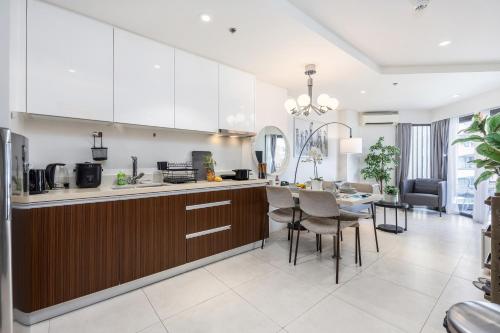 a kitchen and living room with a table and chairs at Dominiks silent and quite Classic 1 Bedroom 47 sqm Tambuli Pool Balcony Beach Mactan up to 6 People in Lapu Lapu City