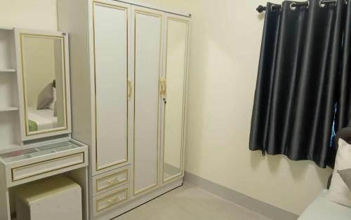 a bathroom with a white cabinet and a mirror at Tranquility House in Ko Lanta