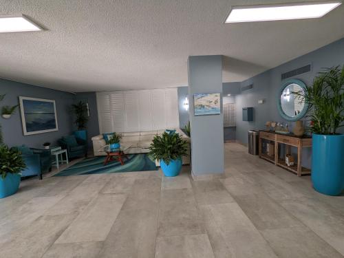 a large living room with potted plants in it at Oceanfront 2Br-2B in Satellite Beach - Ocean Views in Satellite Beach