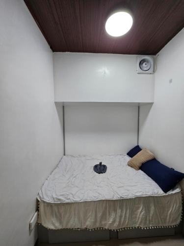 a small bed in a small room with a ceiling at The Roam Inn - Fast Wifi Connection in Dipolog