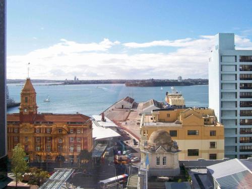 a view of a city with buildings and the water at Mövenpick Hotel Auckland in Auckland