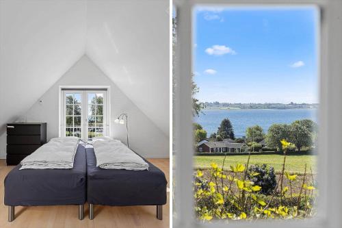 a bedroom with a bed and a view of the water at FY285-Faaborg-Egsgyden-35 in Fåborg