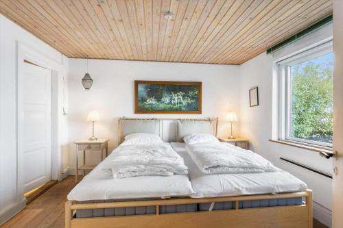 a bedroom with a bed with a wooden ceiling at FY297-Faaborg-Ostergyden-37 in Faaborg