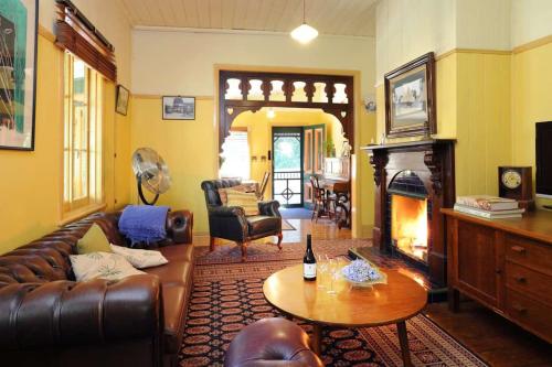 a living room with a couch and a fireplace at Olinda Stay in Olinda