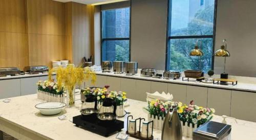a room with a table with flowers on it at Lavande Hotel Yichang Railway East Station Branch in Yichang