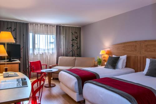 Postel nebo postele na pokoji v ubytování HÔTEL C SUITES chambres spacieuses
