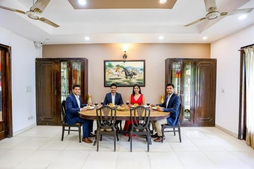 a group of people sitting around a table at FabHotel Pulse Impulse in New Delhi