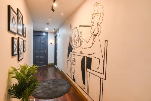a hallway with a mural of a man in a mirror at FabHotel Suncitel - Nr Netaji Subhash Chandra Bose International Airport in Kolkata