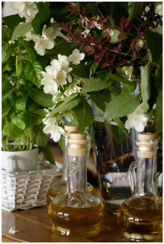 two glass vases with white flowers on a table at Willa Pod Basztą Restauracja&Wellness in Kazimierz Dolny