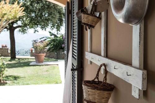 an open door with baskets hanging on the wall at La Fonte Su in Canterano