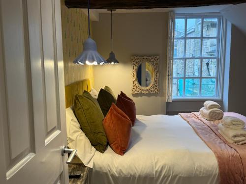a bedroom with a bed with pillows and a window at Dream Stays Bath - Kingsmead Street in Bath