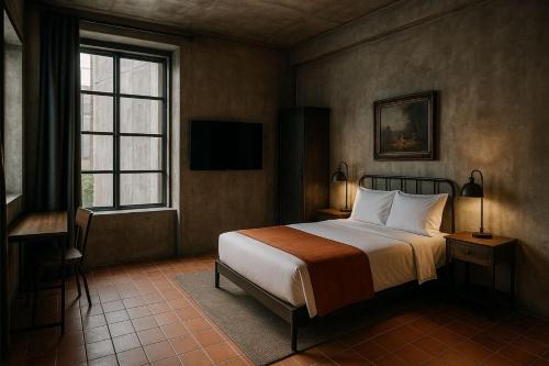 a bedroom with a bed and a television in it at Astroma Vertana in Cloncurry
