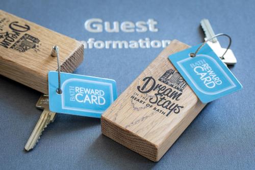 a couple of tags on a piece of wood at Dream Stays Bath - Kingsmead Street in Bath