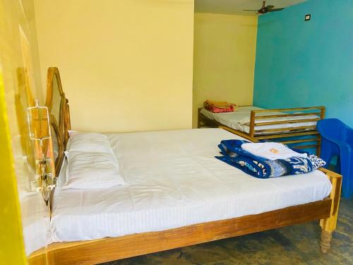 two twin beds in a room with blue walls at Happy Valley Resort Araku in Araku