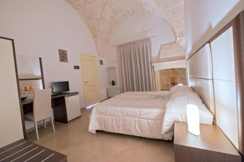 a bedroom with a bed and a desk and a computer at Monte Castello in Villa Castelli