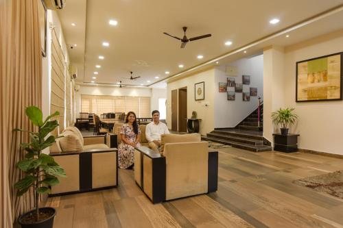 a man and a woman standing in a living room at FabHotel All In One Saltlake - Opp BJ Market Complex in Kolkata