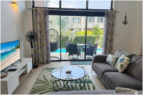 a living room with a couch and a tv at SG5 l Le Turquoise - third line building - Beachfront Residence in Cap Malheureux