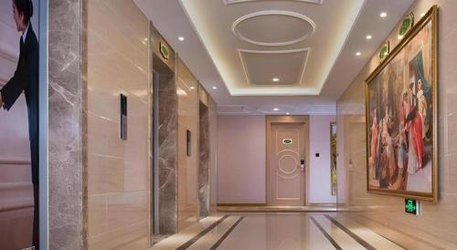 a hallway in a building with a painting on the wall at Vienna Hotel Chengdu North Railway Station North Square Wukuaishi Metro Station in Chengdu
