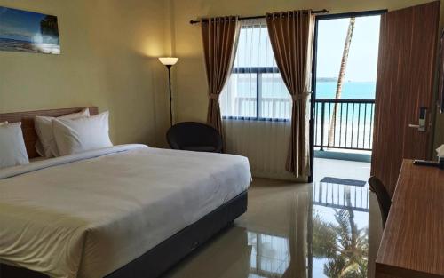 a hotel room with a bed and a balcony at Baga Resort Hotel in Lagudri