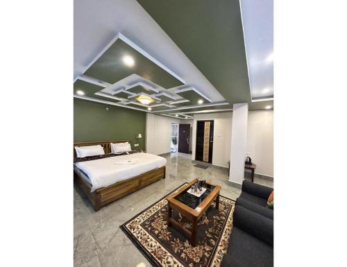 a bedroom with a bed and a couch at Ana SonamTsomu, Tawang in Tawang