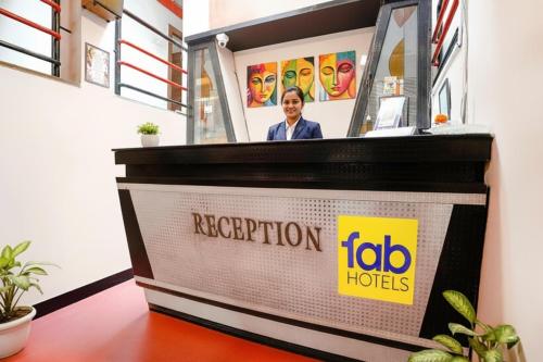 a woman standing behind a podium in a room at FabHotel Saroj Inn - Mumbai Naka in Nashik