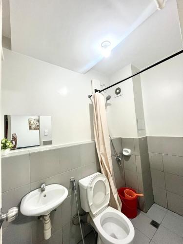 a bathroom with a toilet and a sink at 2BR Family Condo for 6pax near IT Park Budget Stay at Urban Deca Homes Banilad by Gerra unit Nathan in Mandaue City